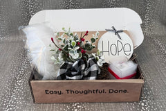 Entry Envy December Refill Decor Kit- pictured: hope sign, snowy greenery pick with ribbon, luminary tea light, snow bag.