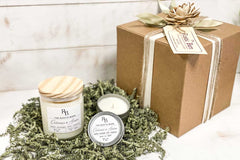 Hands holding a jar candle made of soy with the scent of Egyptian Amber from the Rustic Barn subscription box.