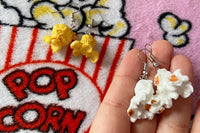 Colorful assortment of unique earrings including food and whimsical designs in the Monthly Earring Mania subscription box
