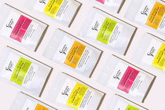 A colorful assortment of Everyday People Coffee & Tea's Great Tasting Sustainably Grown and Ethically Sourced Loose Leaf Tea Subscription on a white background, perfect for gifting.