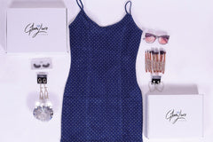 Glam Luxe Box Sample items: Diamond denim mini dress, glam earrings, sunglasses, and makeup brushes.