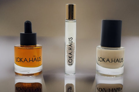LOKA.HAUS: 'Duality Oil' in amber, center 'Intensity Parfum Roller' & right, 'Radiant Serum'. Elegance & quality shine in every drop.