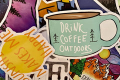 Pic shows assortment of stickers as an example of what can come in a Quirky Pickle pack. In this pic there is a coffee mug sticker.