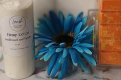 A gift of Lavish Luxury Bath and Body Box next to a blue flower.