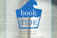 A beach scene with a subscription box from BookTIDE featuring great reads and colorful glass floats