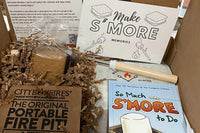 Smore memories box, portable fire pit,  handmade marshmallows, gram crackers and chocolate, so much smore to do book, and roasting sticks.