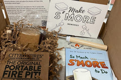 Smore memories box, portable fire pit,  handmade marshmallows, gram crackers and chocolate, so much smore to do book, and roasting sticks.
