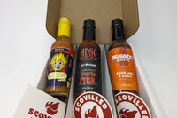 SCOVILLED hot sauce of the month subscription box featuring Stanky Sauce, High Desert Sauce Co., and Bravado Spice Co.