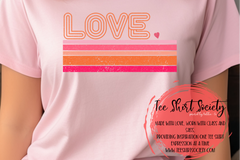Pink T-shirt with the work love on it in a retro font that's a peach color, with thick lines under it in shades of pink and peach.