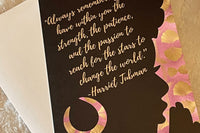 Silhouette of a black woman with an afro praying with a Harriet Tubman quote in her hair.  Background is purple and gold african print.