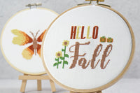 hello fall words on this simple cross stitch chart with orange pumpkins and tall sunflowers, simple butterfly pattern for beginners.