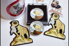 Vinny's trading pin's design is inspired by an authentic photograph of Vinny the Pug atop a boulder in Papago Park.