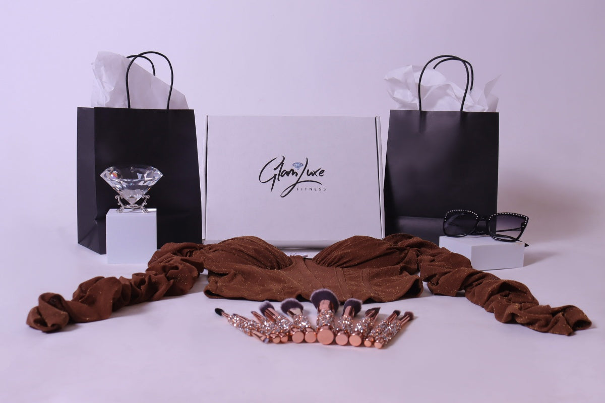 Glam Luxe Box with diamond makeup brushes, diamond sunglasses, and a long sleeve sparkle corset top.