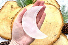 A photo of a pink calcite bowl in the shape of a crescent moon offered by Soul Gifts Crystals as a crystal of the month.