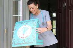 Nurse with stethoscope on front porch looking at Nightingales Mail box and opening it with smile on her face