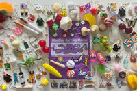 Colorful assortment of unique earrings including food and whimsical designs in the Monthly Earring Mania subscription box