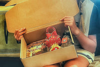 A box opened up and waiting to be gone through. These gifts bring the reader the same experiences as the book characters. So fun!