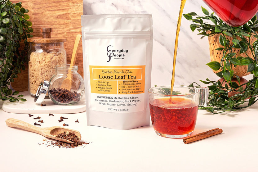 A gift bag with Everyday People Coffee & Tea's Great Tasting Sustainably Grown and Ethically Sourced Loose Leaf Tea Subscription and a cinnamon stick.