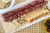 Truffle pairingsTruffle pairings Tapas box Spread tray including Cured meat fuet, Aged mixed milk cheese, Truffle pistachios and crackers