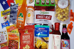 Pictured: Bucc-ees nuggets, pecan carmel popcorn, mexican seasonings, organic jerky, mexican cornbread mix, BBQ sauce, and Texas soda pops.