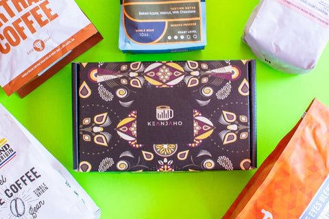 This photo contains several coffee bags along with packaging for the Keanjaho coffee subscription shipment.