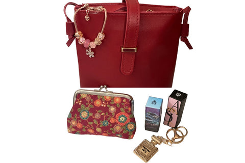 September '23 Ladies Box contains a crossbody bag, coin purse, 2 3ml parfum samples, keychain and rose gold toned Pandora style bracelet.