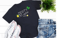 Navy blue tshirt that says Zesty Nurse with lemons and limes and the U in Nurse is a stethoscope with a lemon at the end, white converse 
