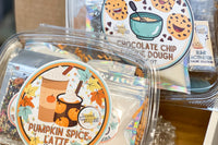 Close up cropped view of November Box including pumpkin spice latte slime kit and cookie dough slime kit. Bright colorful graphics, so cute.
