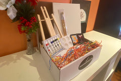 Enjoy a Paint and Sip Box or give as a gift. Each box contains an easel, a canvas, paint, a tray, and brushes. 