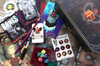 Dungeon Crate subscription box featuring dice, cards, a figurine, and roleplaying accessories for D&D enthusiasts