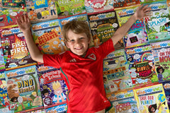 Boy with large collection of Whizz Pop Bang magazines – the awesome science magazine for kids aged 6 to 12.