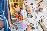 Two thejewelpick gift cards being held and played by a woman in two pictures.