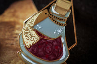 Gold plated, hard enamel pin depicting Dragon's blood in a translucent enamel bottle. Printed details and scroll, the potion is swirled.