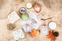 Bath Bevy subscription box with colorful bath bombs, a candle, and self care items for gifts for women
