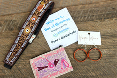 Peru & Guatemala Box of Blessings featuring an embroidered headband, smooth wooden hoops, and an embroidered coin purse. 
