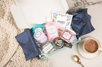 Hygge Mood Tubless Bath Bevy Subscription Box with shower steamers, body butter, bar soap, body wash, whipped soap scrub and candle