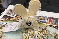 A hand sewn Easter Bunny, with embroidered face, filled with candies. 2 table top centerpiece mats. These are sewn by hand and reversable. 