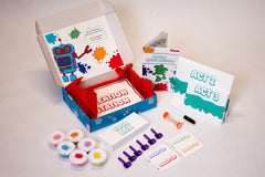 Open Hello Family kit featuring Doughbot's Creation Lab with colorful red tissue paper all of the included activities.
