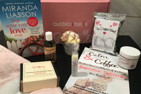 Bubbles & Books subscription box featuring a romantic novel, handmade soap, and bath products for relaxation