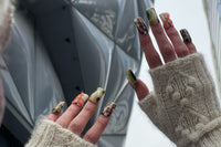 Editorial press-om nails. Olive green, cream, and brown. Abstract dots and blooming gel effect. Croc inspired. Orange mesh net.