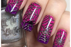 Nails with nail art- purple to fuschia gradient with black and silver holographic spider webs stamped for My Mani Box nail art subscription.