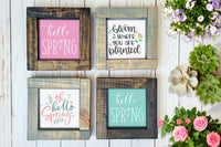 Brown and gray wood framed signs in various designs. Pink and blue "hello spring", bloom where you are planted signs.