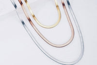 Tri color herringbone Set in a layered style design with each necklace one inch length off of the other  on a single clasp