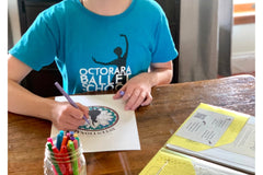 Dancer using her Ballet Kit for Teens & Tweens. Worksheets, coloring pages, ballet history, charms for dance bag and more!