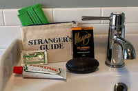 Photograph includes Euthymol toothpaste, Mango Classic soap, a Stranger's Guide bath case, Picot antacid, and a South Korean "Italy" towel.