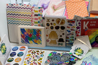 Pic shows an assortment of items as we prepare to pack them into subscriber packs based on age range. 