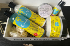 A batch of Her Crown and Glory subscription box featuring products from Curls Blueberry Bliss collection 