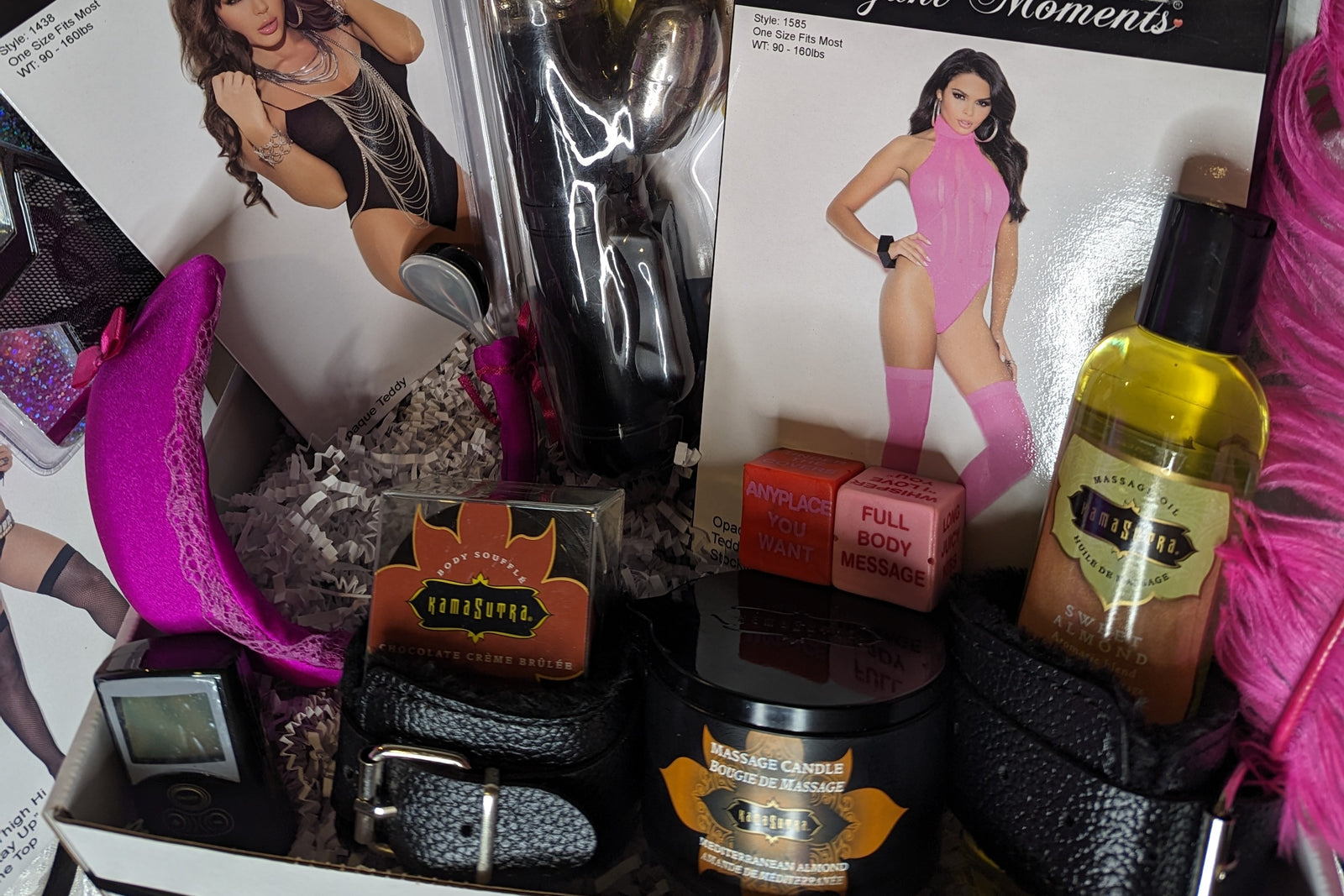 Adult goodie box with body oil, lingerie, handcuffs, vibrating underwear, body candle, love dice, body chocolate, thigh highs, & vibrator