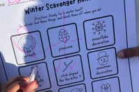 Child enthusiastically completing a recording sheet from The Activity Trunk for a winter scavenger hunt, noting various discovered items