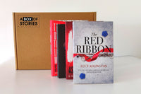 Brown subscription box filled with four surprise mystery books, featuring captivating stories and intriguing plots for genre enthusiasts.